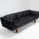 Illum Wikkelso model V11 sofa in black leather by Holger Christiansen, Denmark, 1960