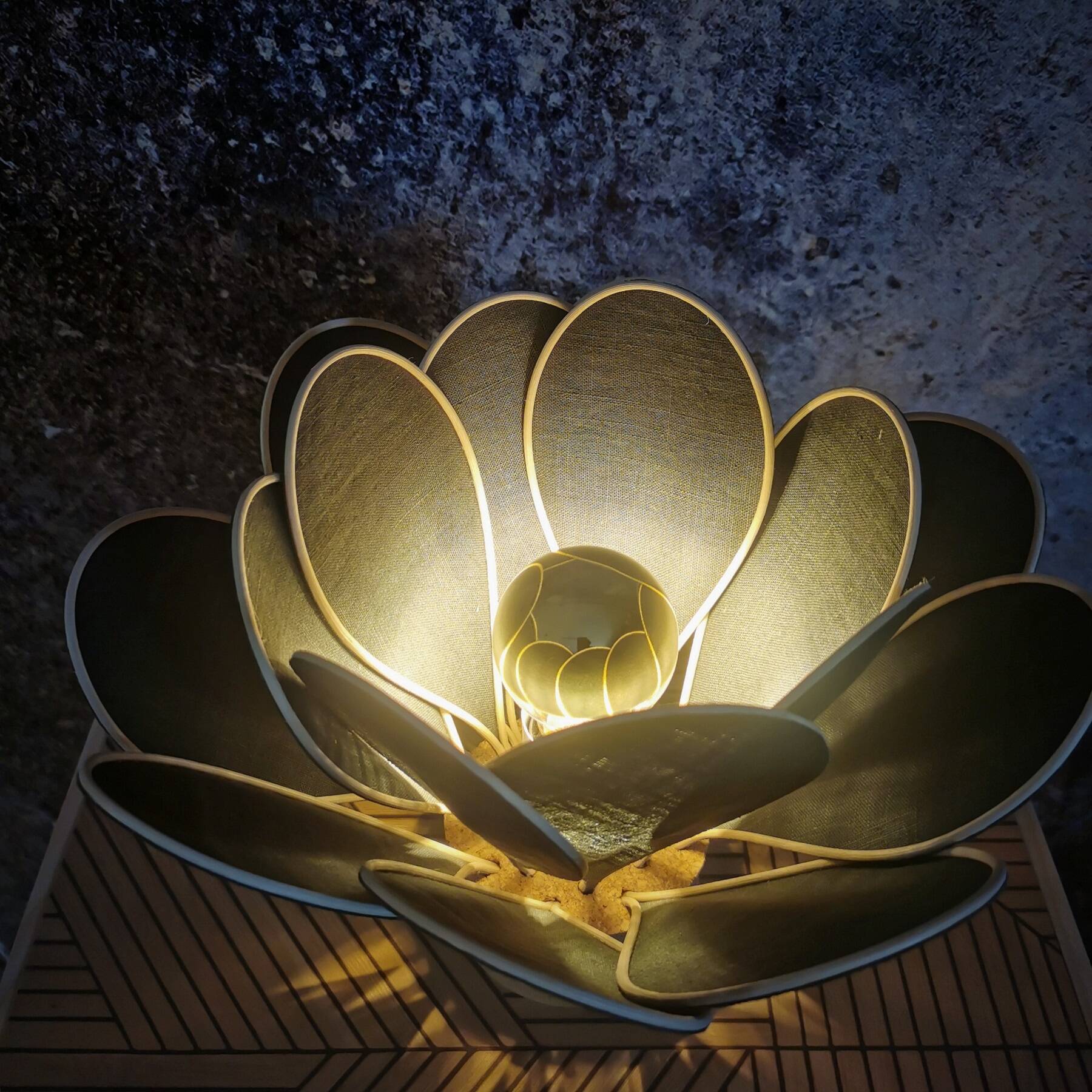 Flower table lamp made of rattan and fir green linen petals