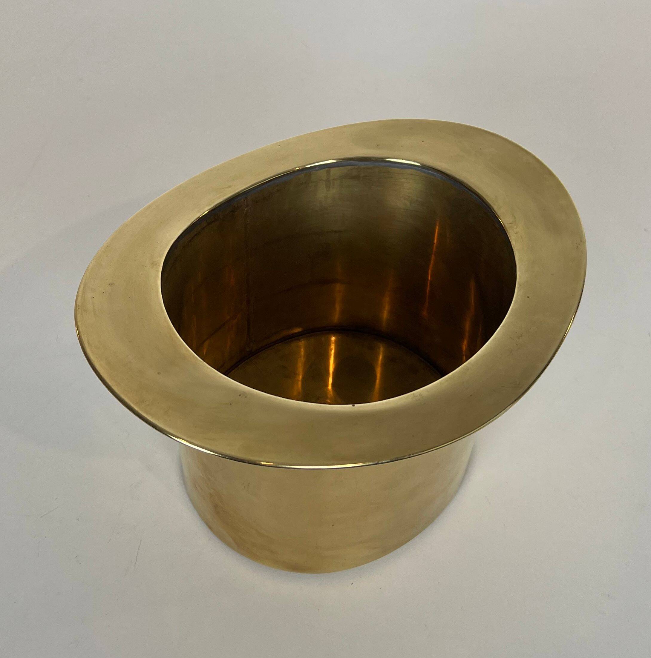 Champagne cooler shaped like a brass top hat.
