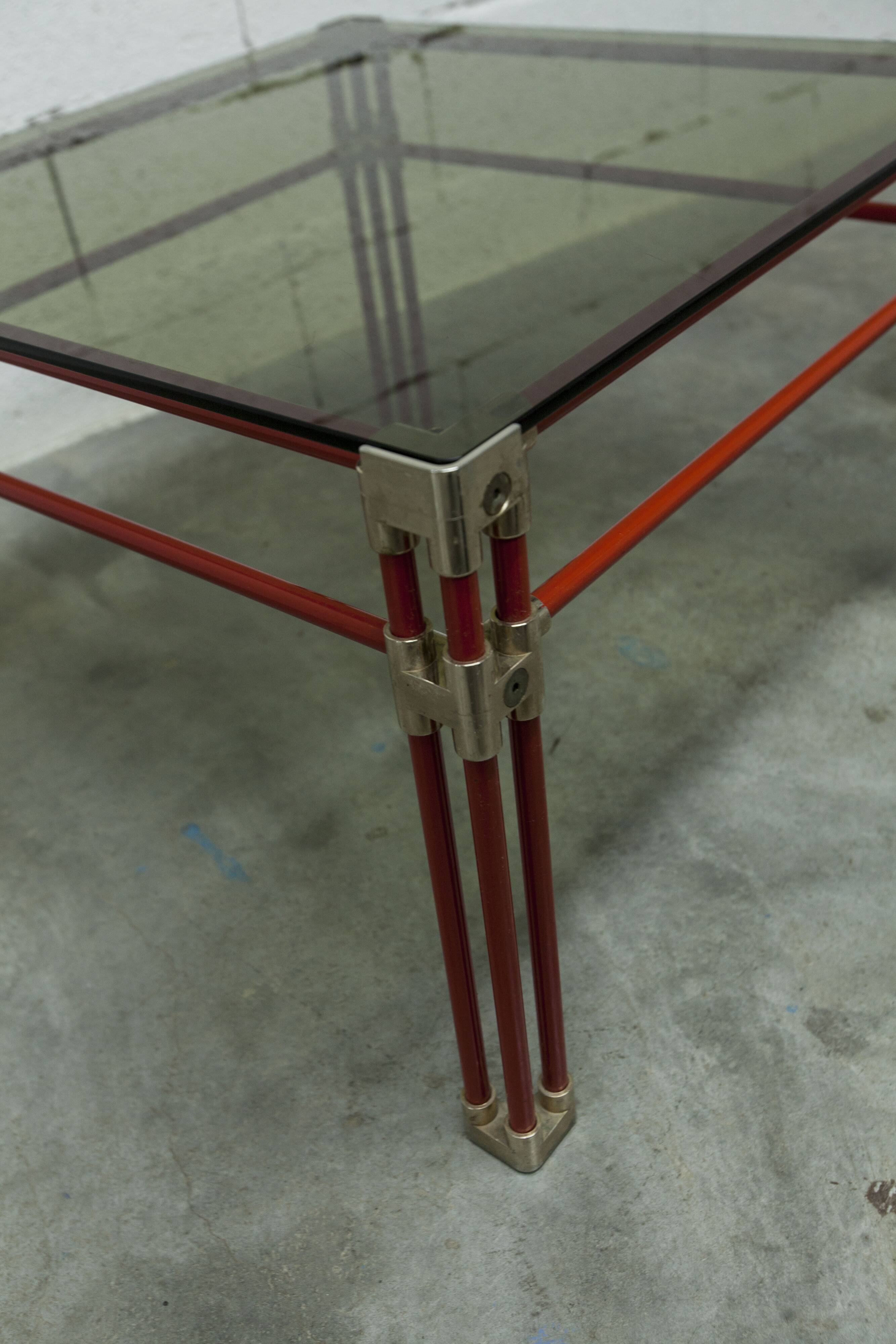Postmodern Italian design coffee table in smoked glass with red steel structure