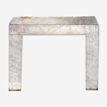 Old fireplace in white marble veined Louis XVI