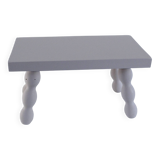 Small vintage wooden bench renovated in pinkish beige