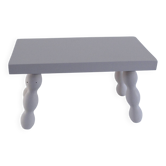 Small vintage wooden bench renovated in pinkish beige