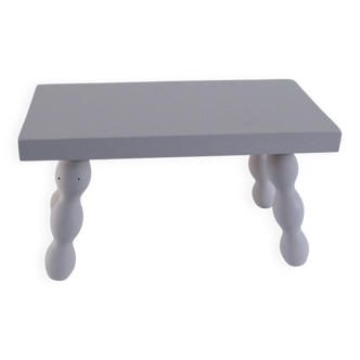 Small vintage wooden bench renovated in pinkish beige