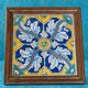 Panel of four Catalan tiles, 17th century, framed.
