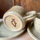 Two large Jean Austruy stoneware cups and saucers