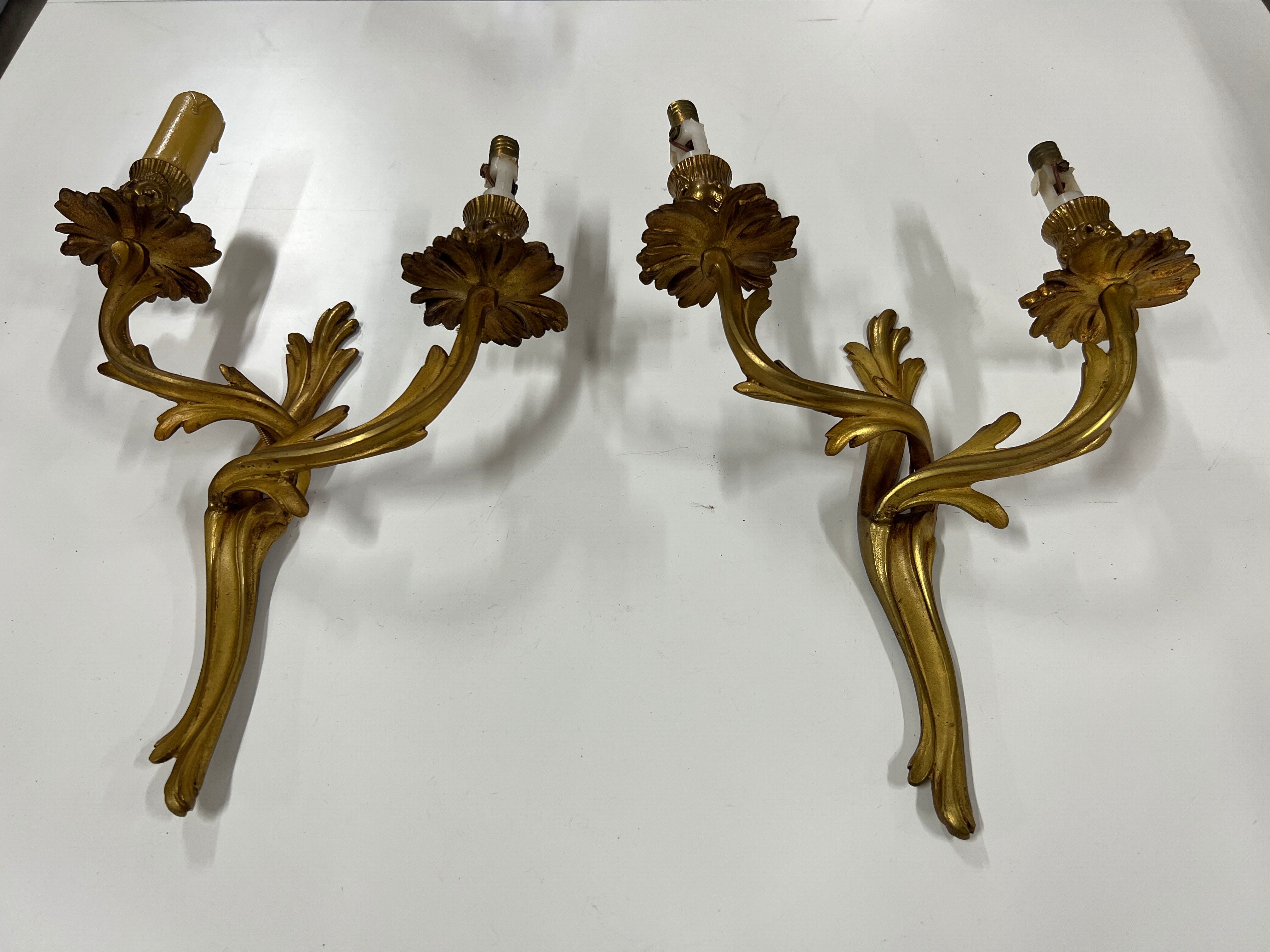 Pair of Louis XV wall lamps in gilded bronze