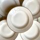 9 hollow plates in white and golden Limoges porcelain