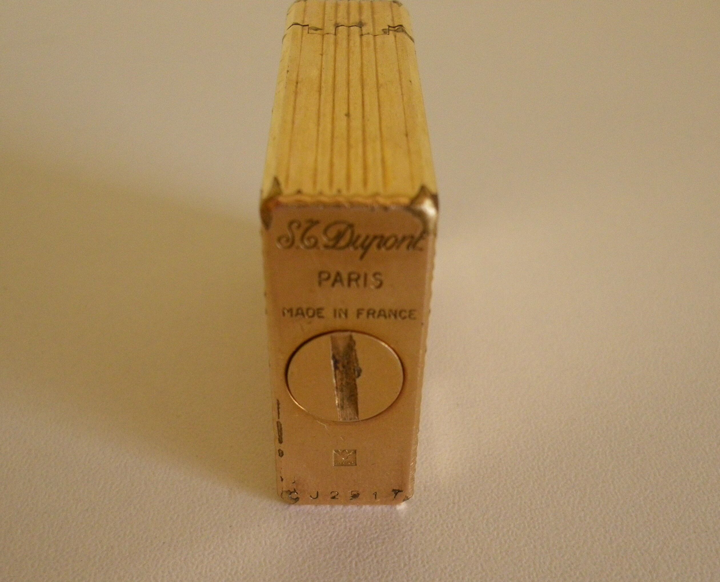 2 st dupont lighters, gold plated, punches, numbered, 1 striated pattern, 1 hammered pattern, 70s