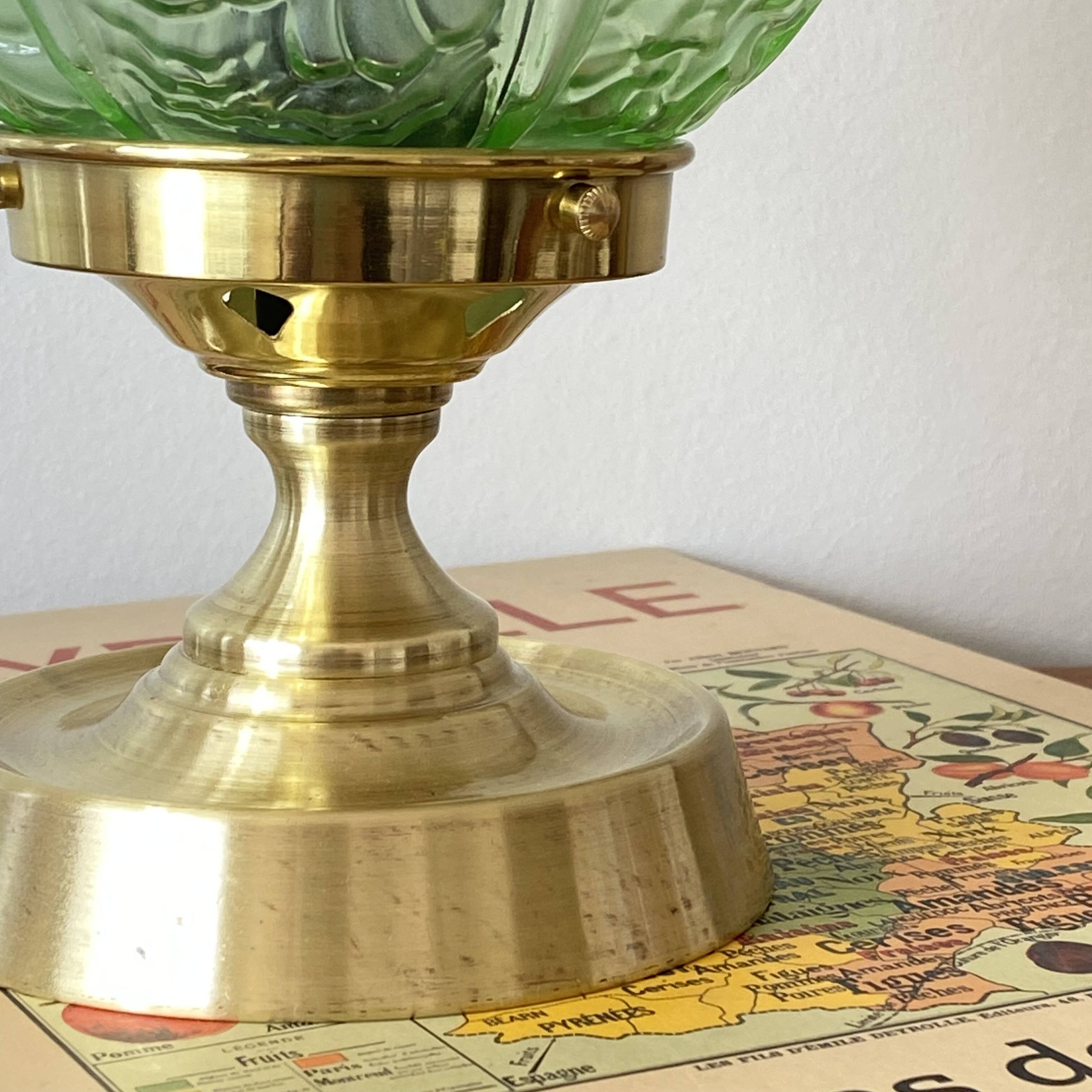 Art Deco green moulded glass globe table lamp with a brass base.