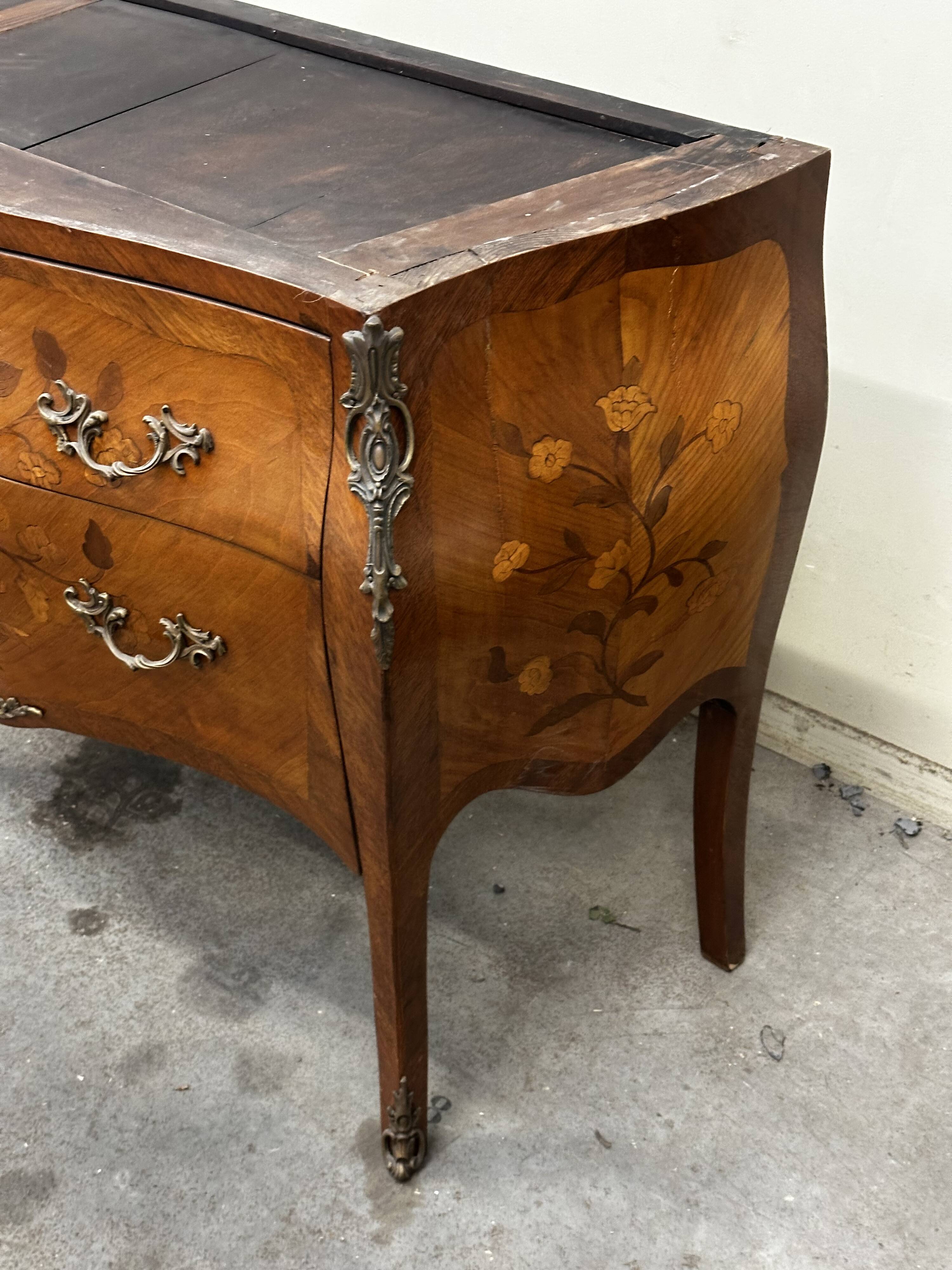 Curved and inlaid Louis XV style chest of drawers