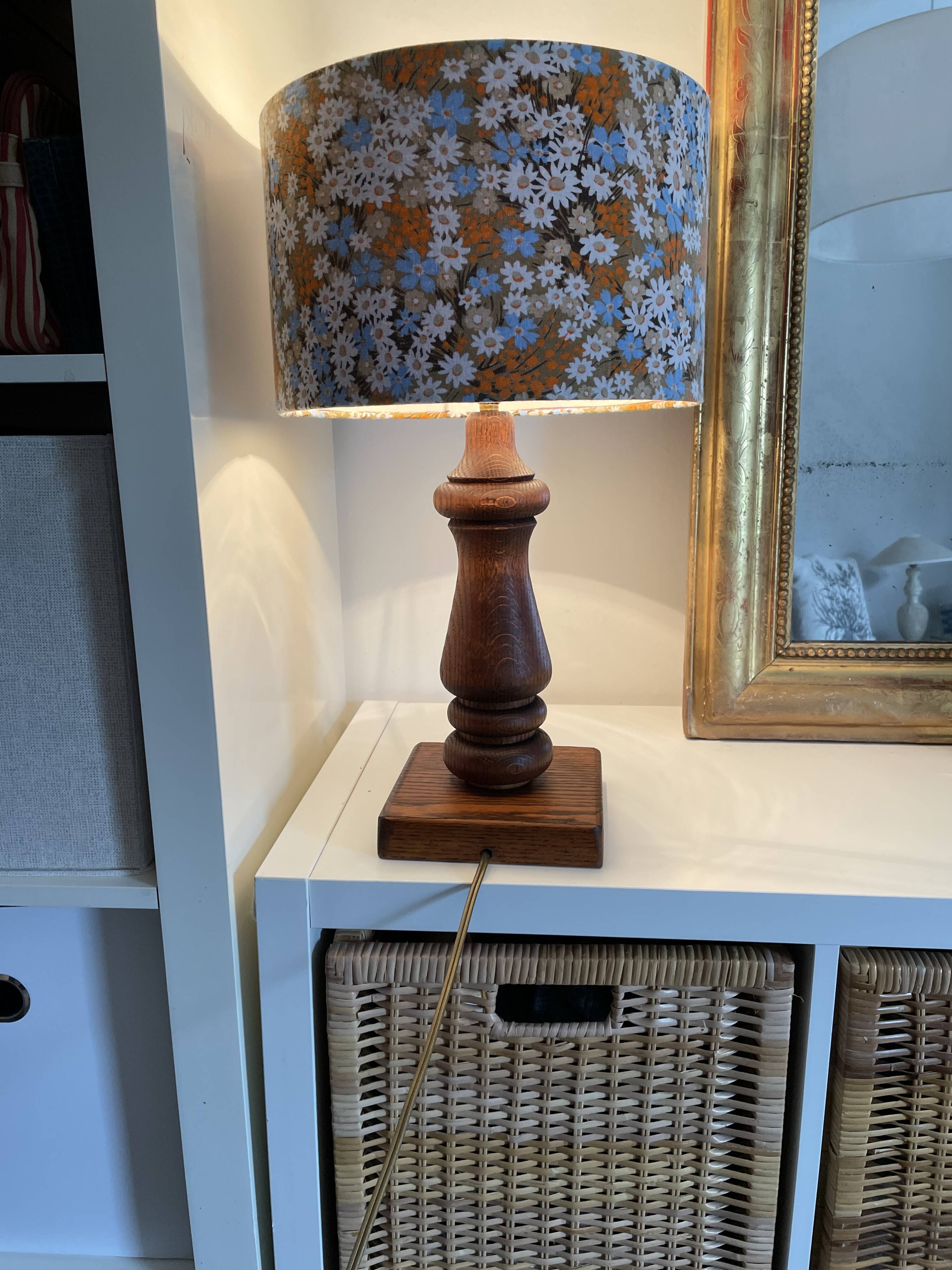 Vintage turned wood table lamp with floral drum shade.