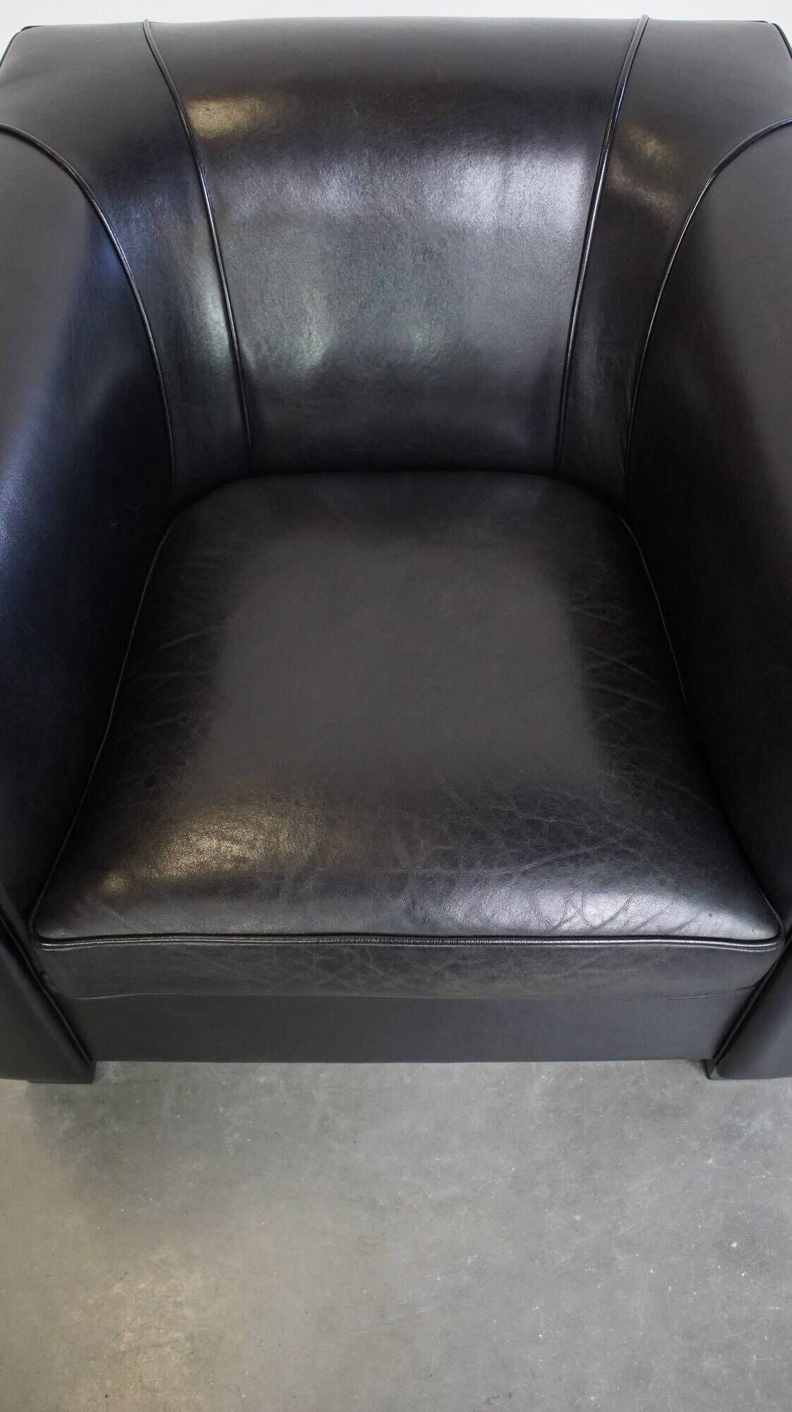 Very comfortable black Art Deco design armchair, made of sheepskin leather