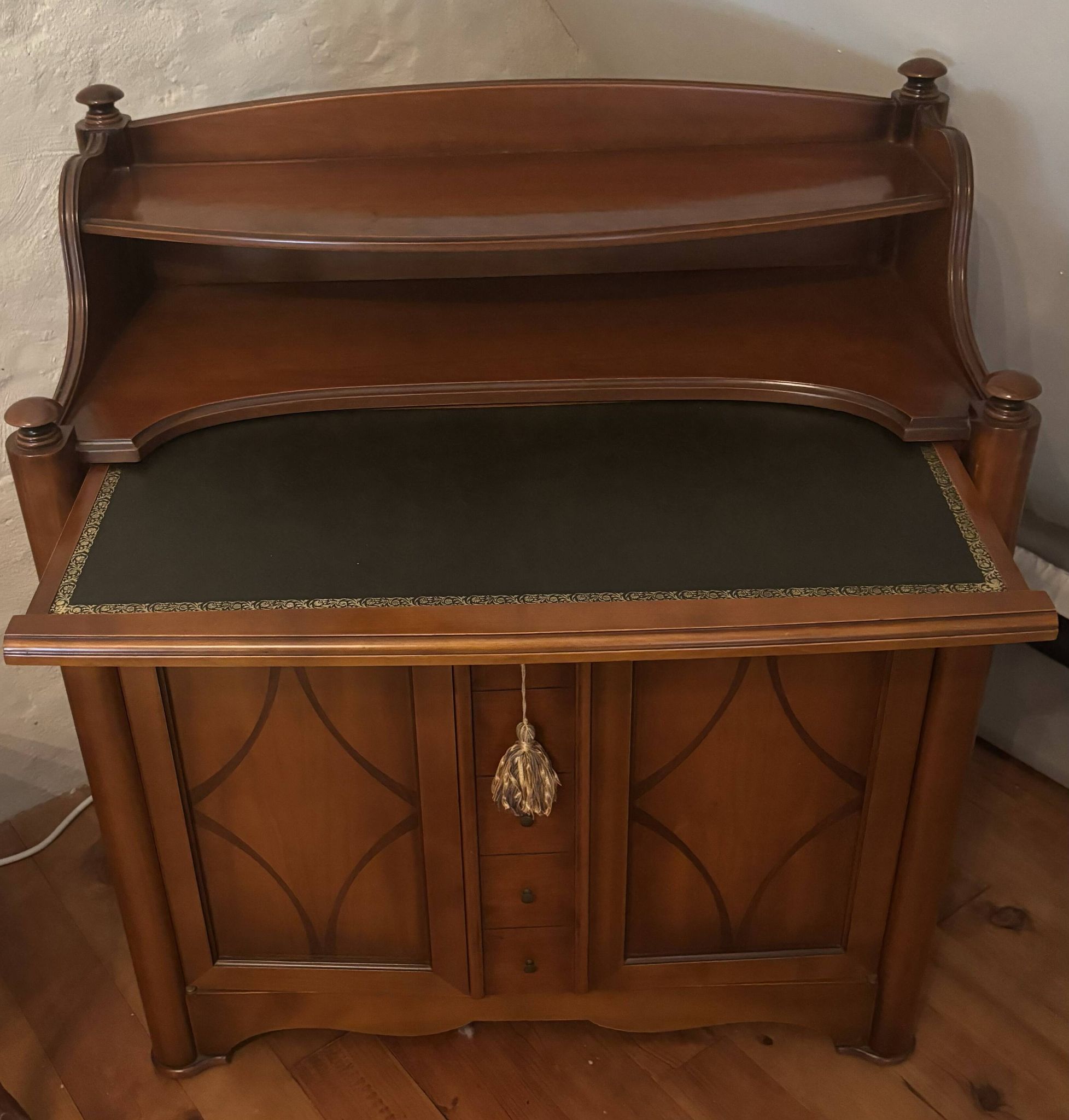 Vintage drop-leaf secretary with a green leather top and inlays.