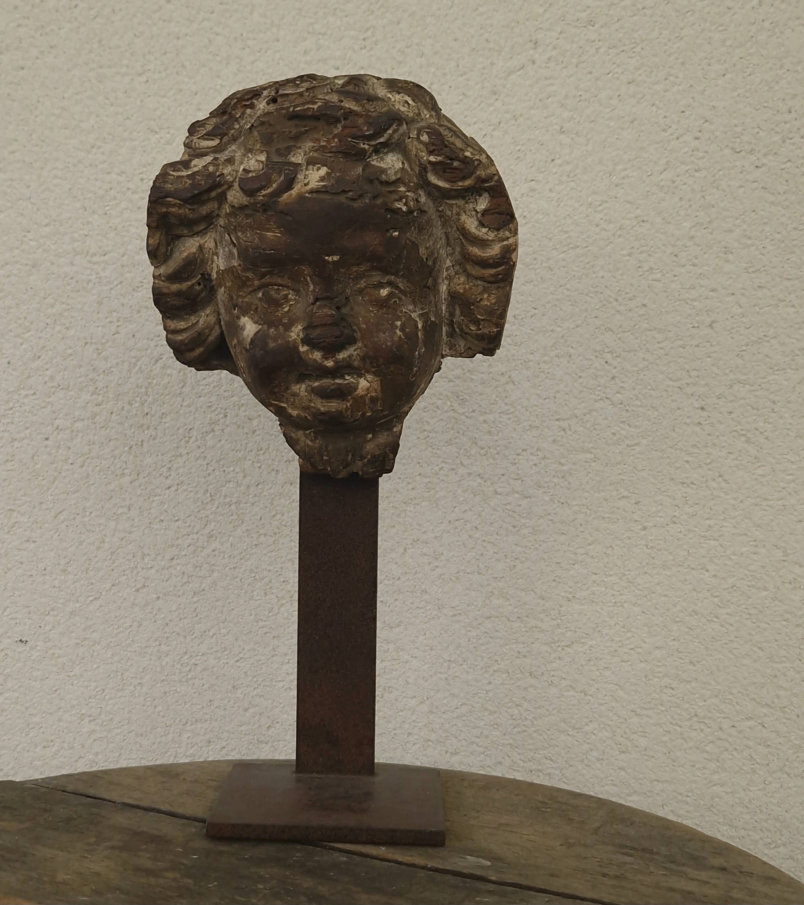 Sculpture. Ancient wooden angel head.