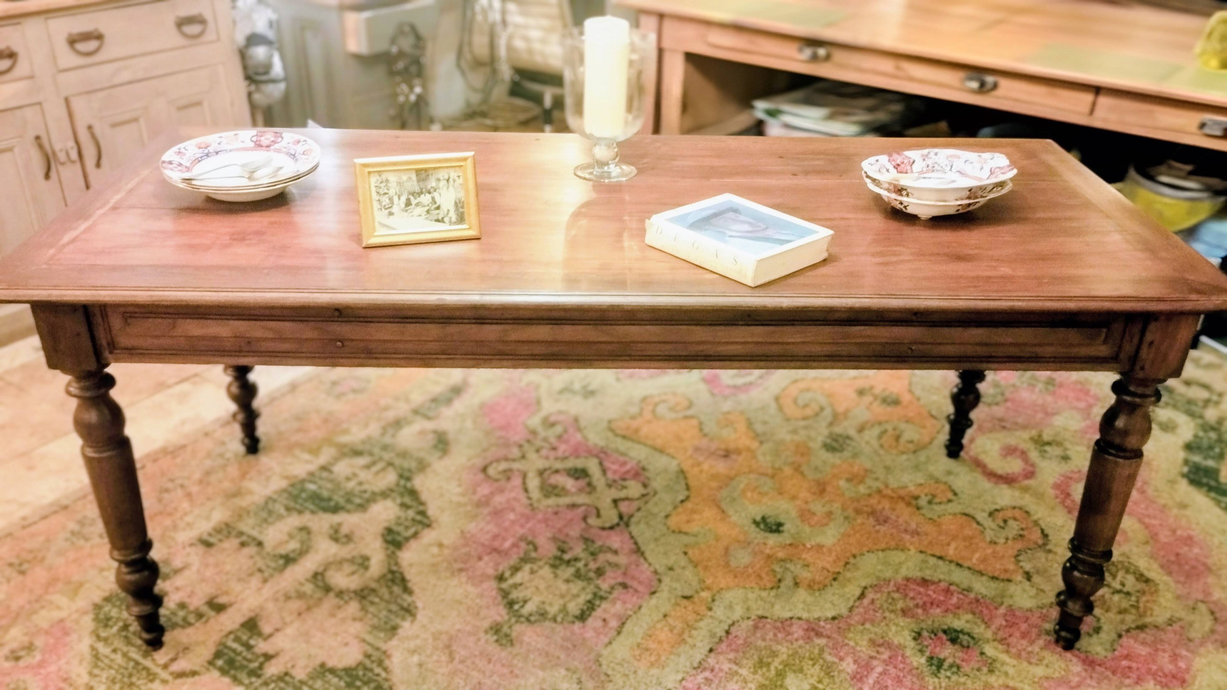 Old French farmhouse table in walnut with turned legs.