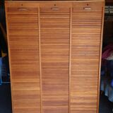 Filing cabinet has curtains, notary furniture. 3 columns