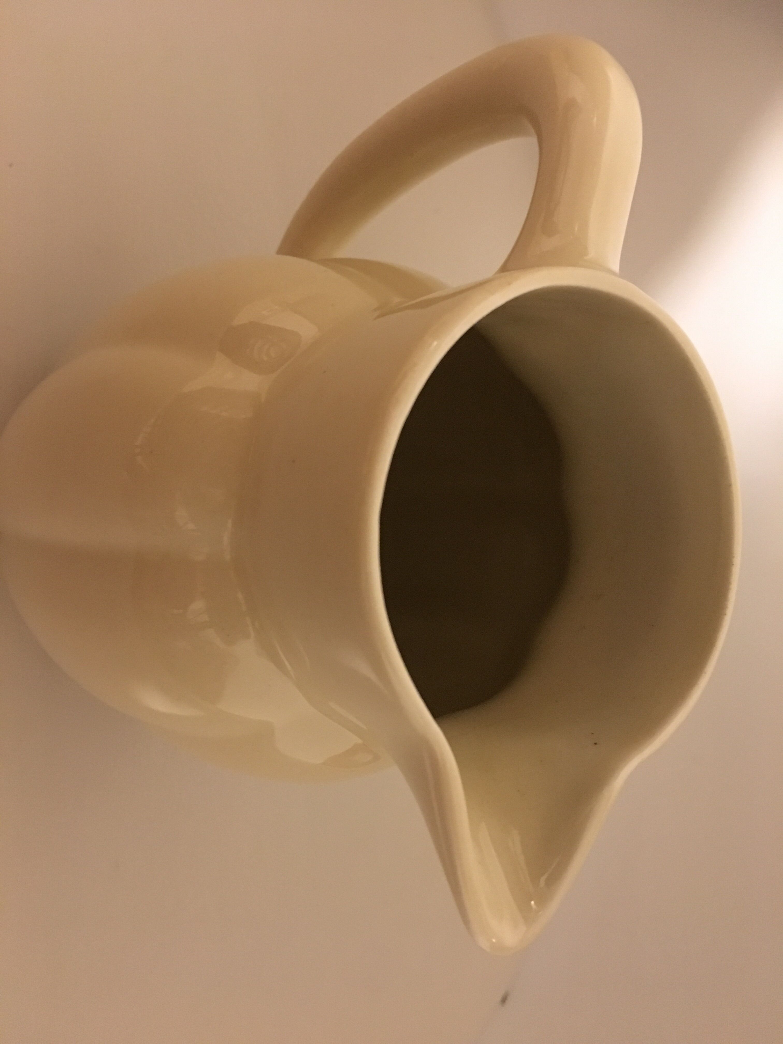Cream color earthenware pitcher