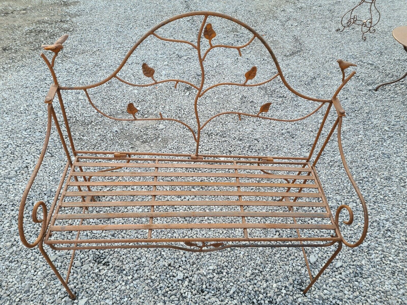 Wrought iron garden bench with birds