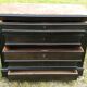Blackened wooden chest of drawers with 5 drawers