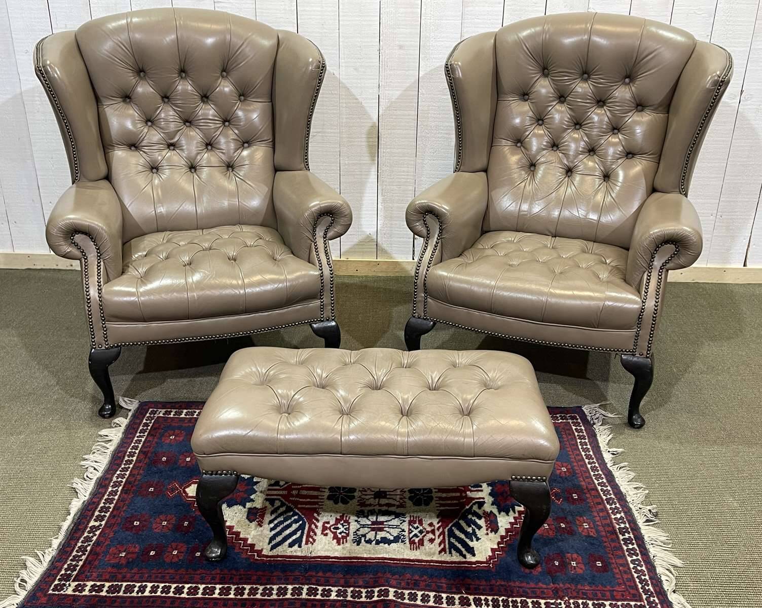Pair of high-backed Chesterfield armchairs with 1 leather footrest