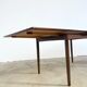 Rosewood dining table with integrated extensions — Denmark, 1960s