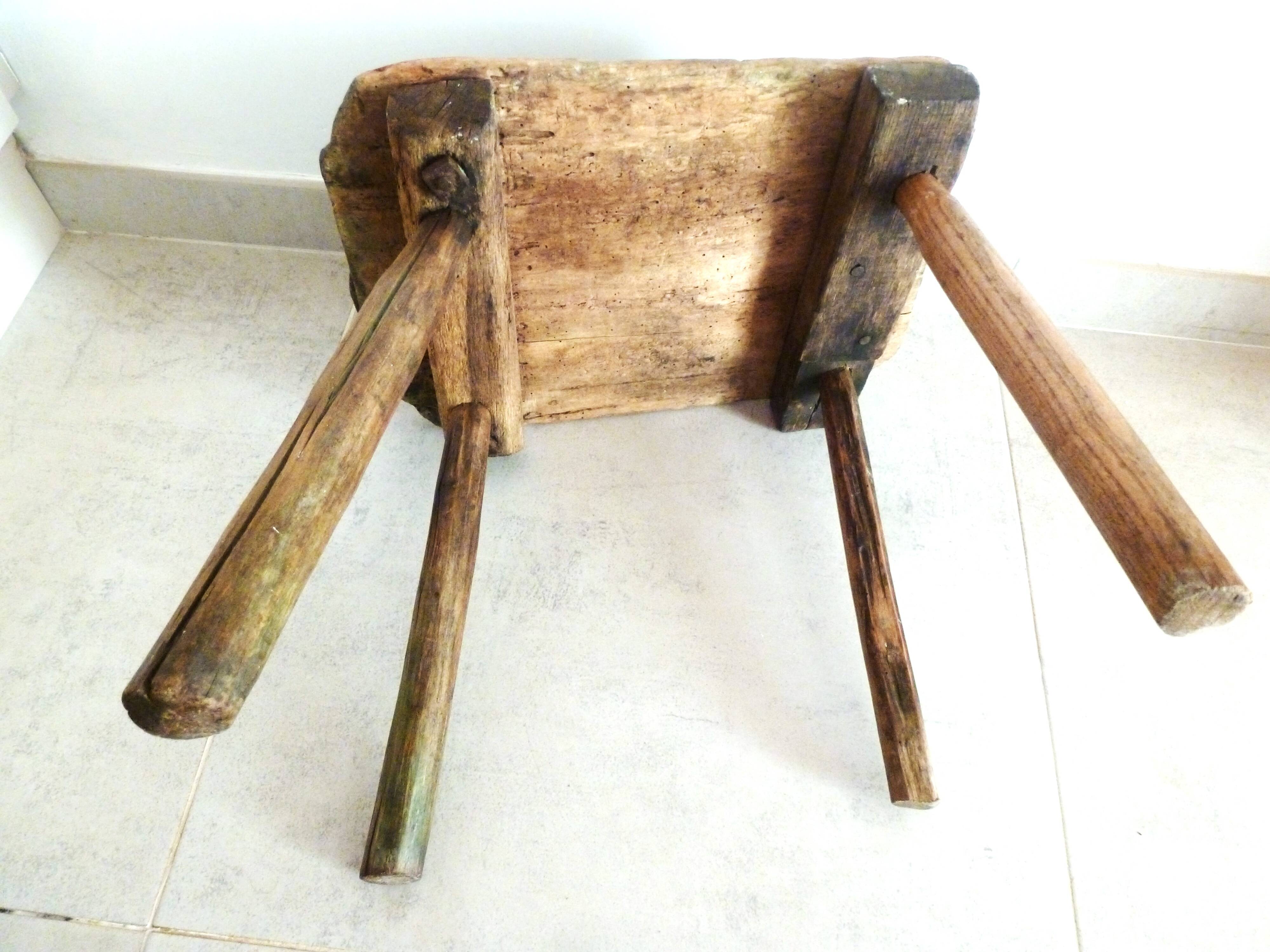 Old milking stool, old farm stool, primitive art.