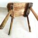 Old milking stool, old farm stool, primitive art.