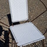 Old relax armchair in black metal and white plastic cannage