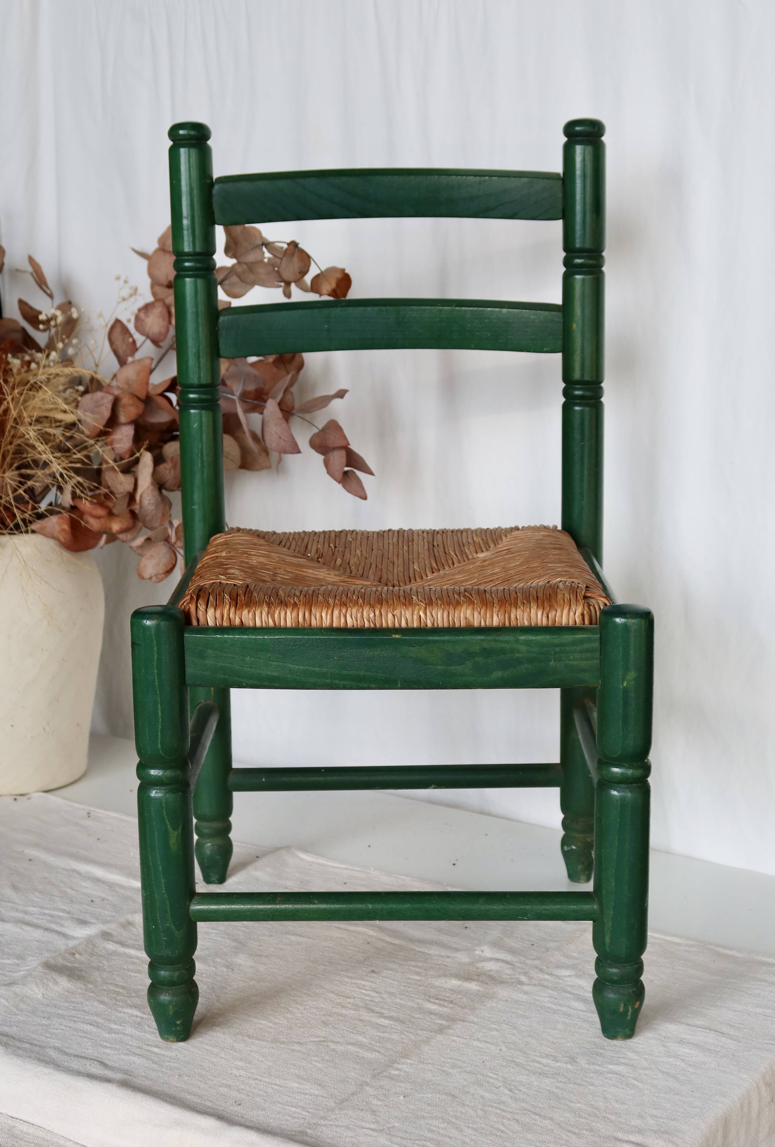 Vintage children's chair in green wood with a woven straw seat