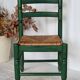 Vintage children's chair in green wood with a woven straw seat