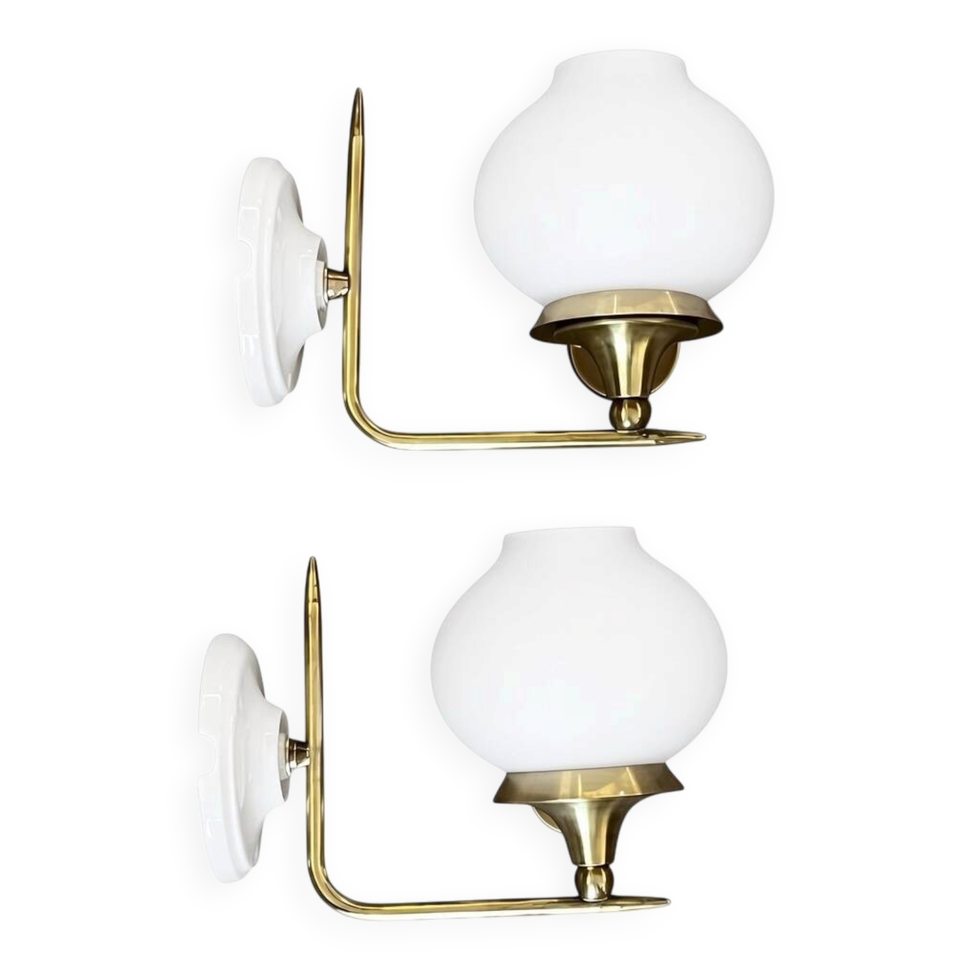 Pair of vintage wall sconces in brass with white glass globe shades.