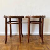 2 antique bistro stools with curved wood and caning effect.