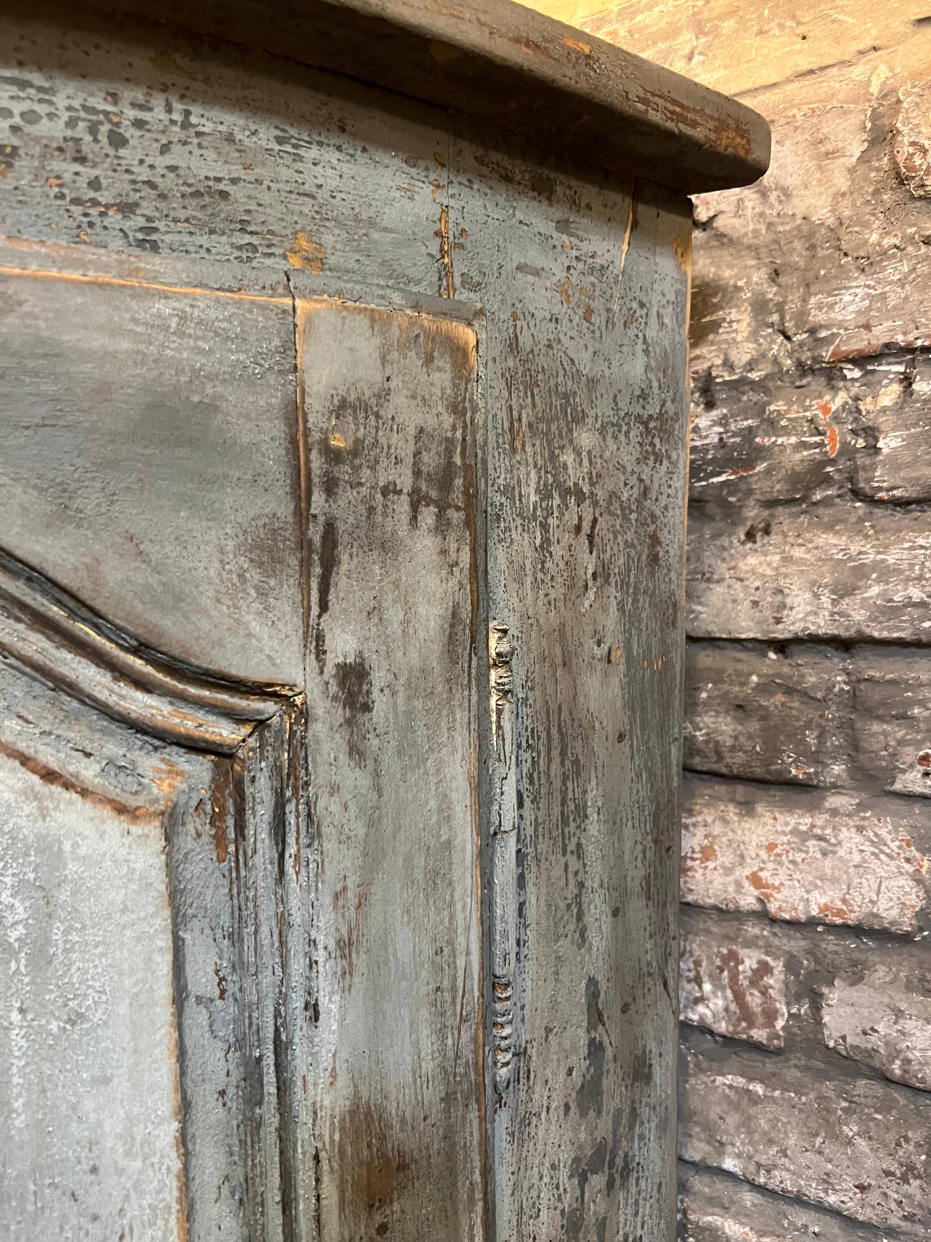 Eighteenth-century corner cabinet with a patina.