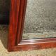 Large antique mirror in a flame mahogany frame; 132x82 cm