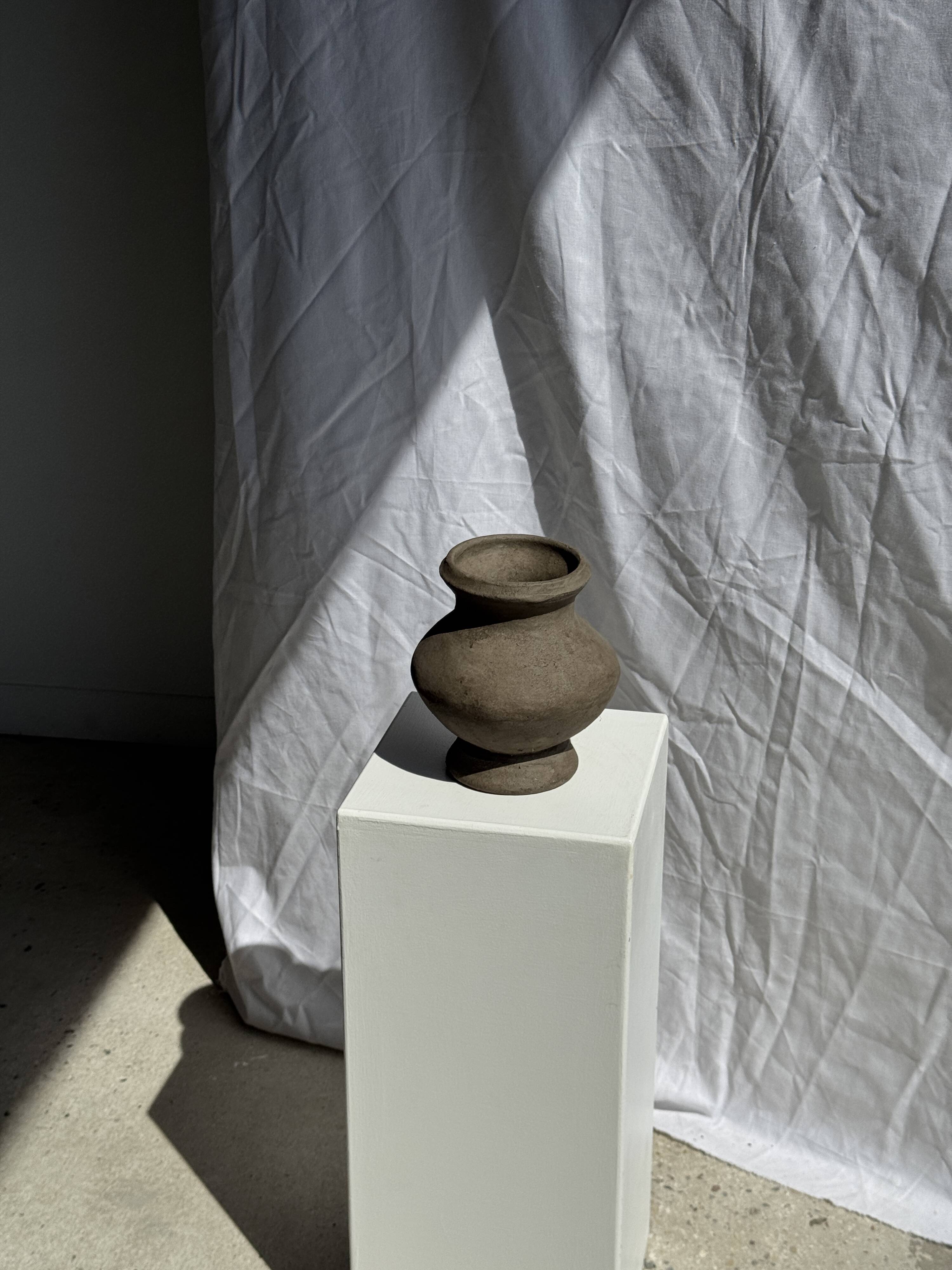 Small brutalist handcrafted terracotta vase with a pedestal, Indonesian, H19 D17.