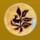 Terracotta plate, Jean Lurçat decorated with a character on a white background.