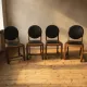 Set of four vintage wooden dining chairs with black leather upholstery, 85 × 45 × 45 cm