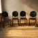 Set of four vintage wooden dining chairs with black leather upholstery, 85 × 45 × 45 cm