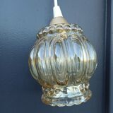 Suspension in molded glass golden reflection