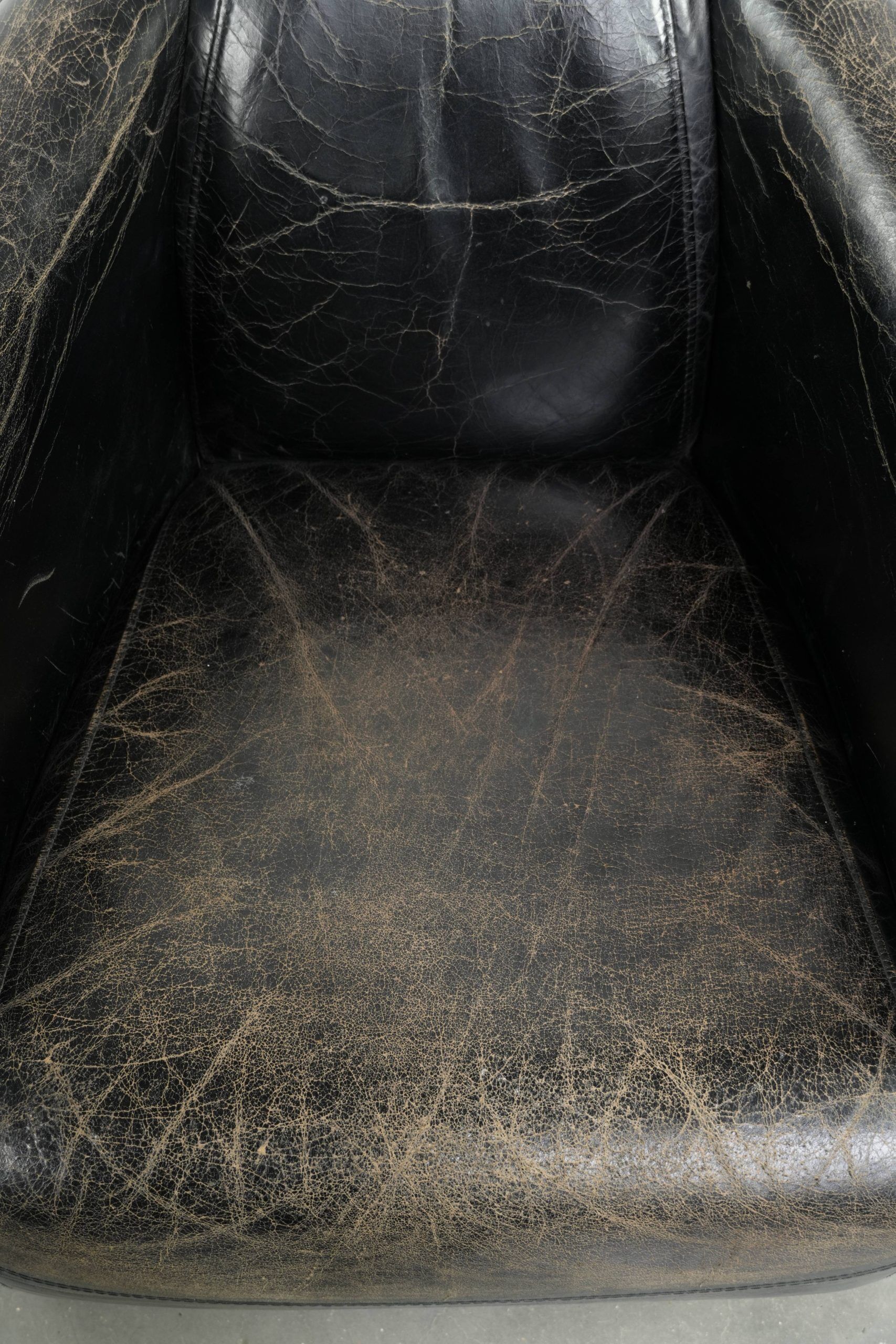 Black vintage cowhide aviator design armchair with characterful appearance