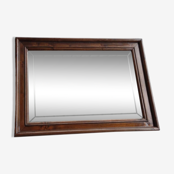 Old beveled mirror with wooden frame