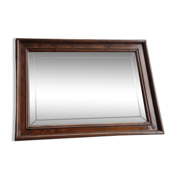 Old bevelled mirror with a wooden frame.