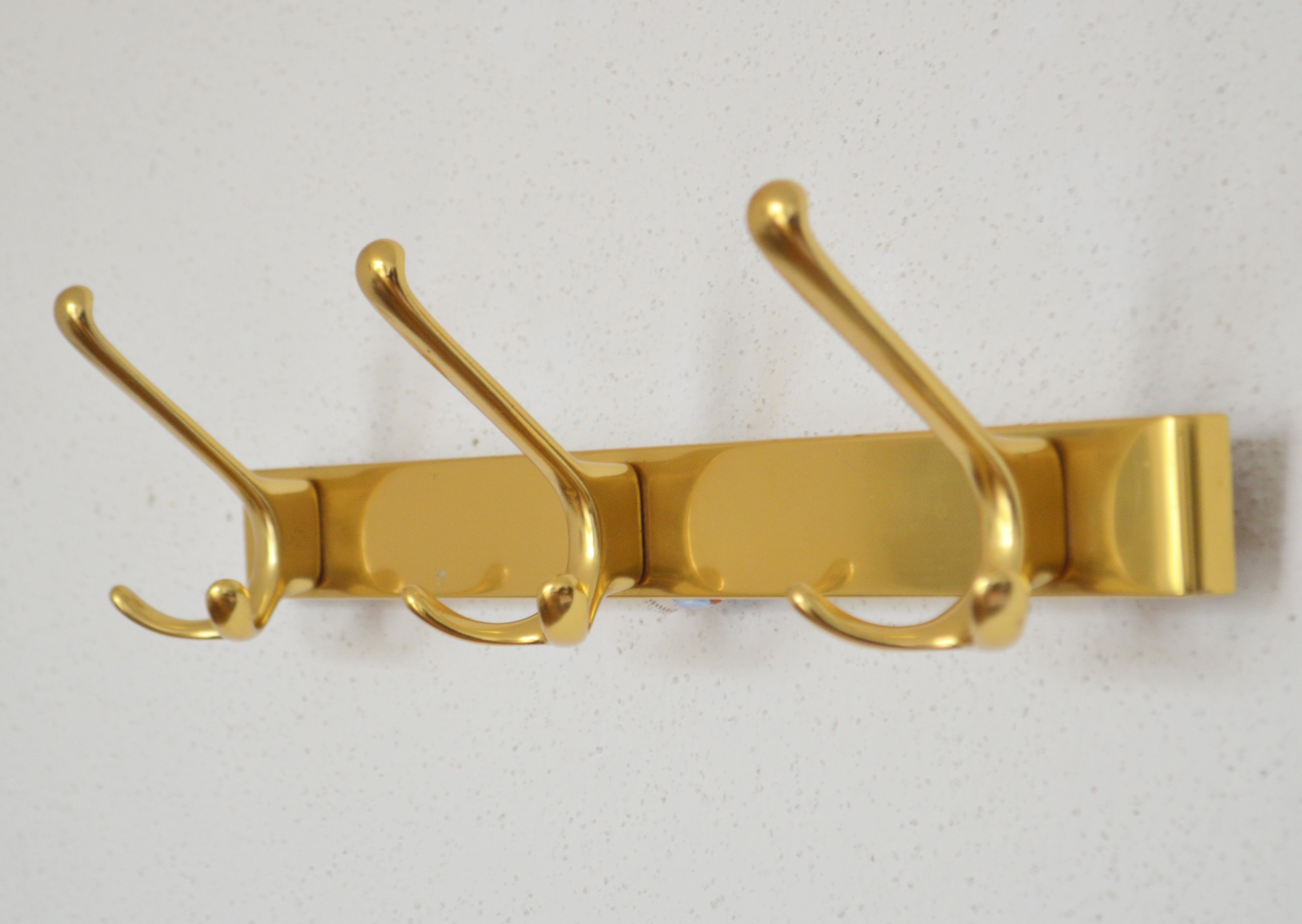 Brass wall-mounted coat rack in Bauhaus style from the 1950s