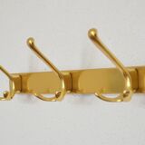 Brass wall-mounted coat rack in Bauhaus style from the 1950s