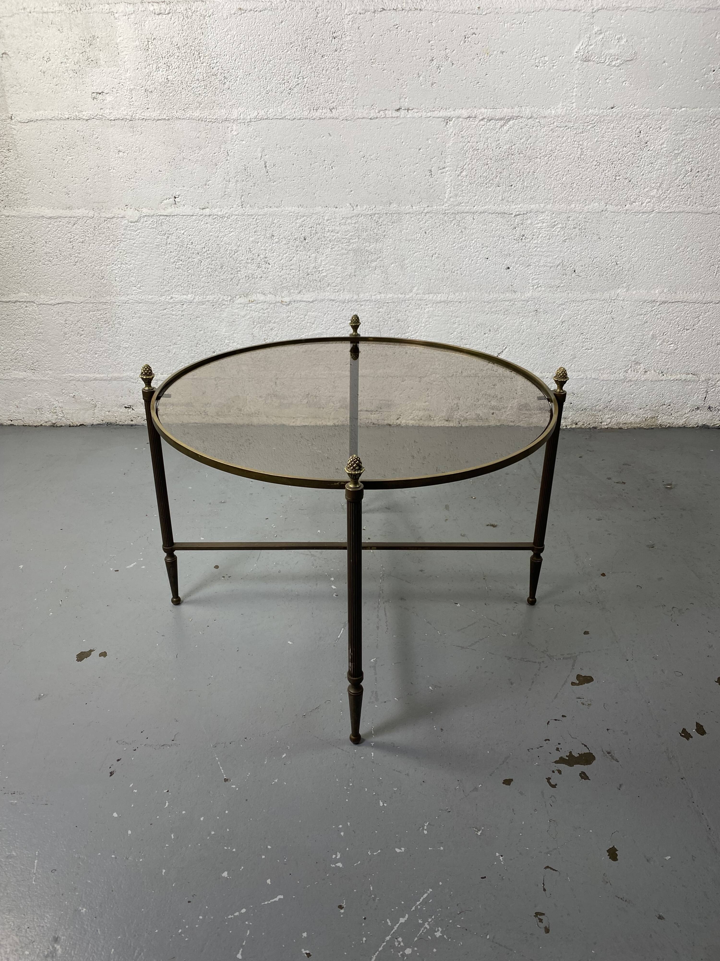 Round coffee table in brass and smoked glass
