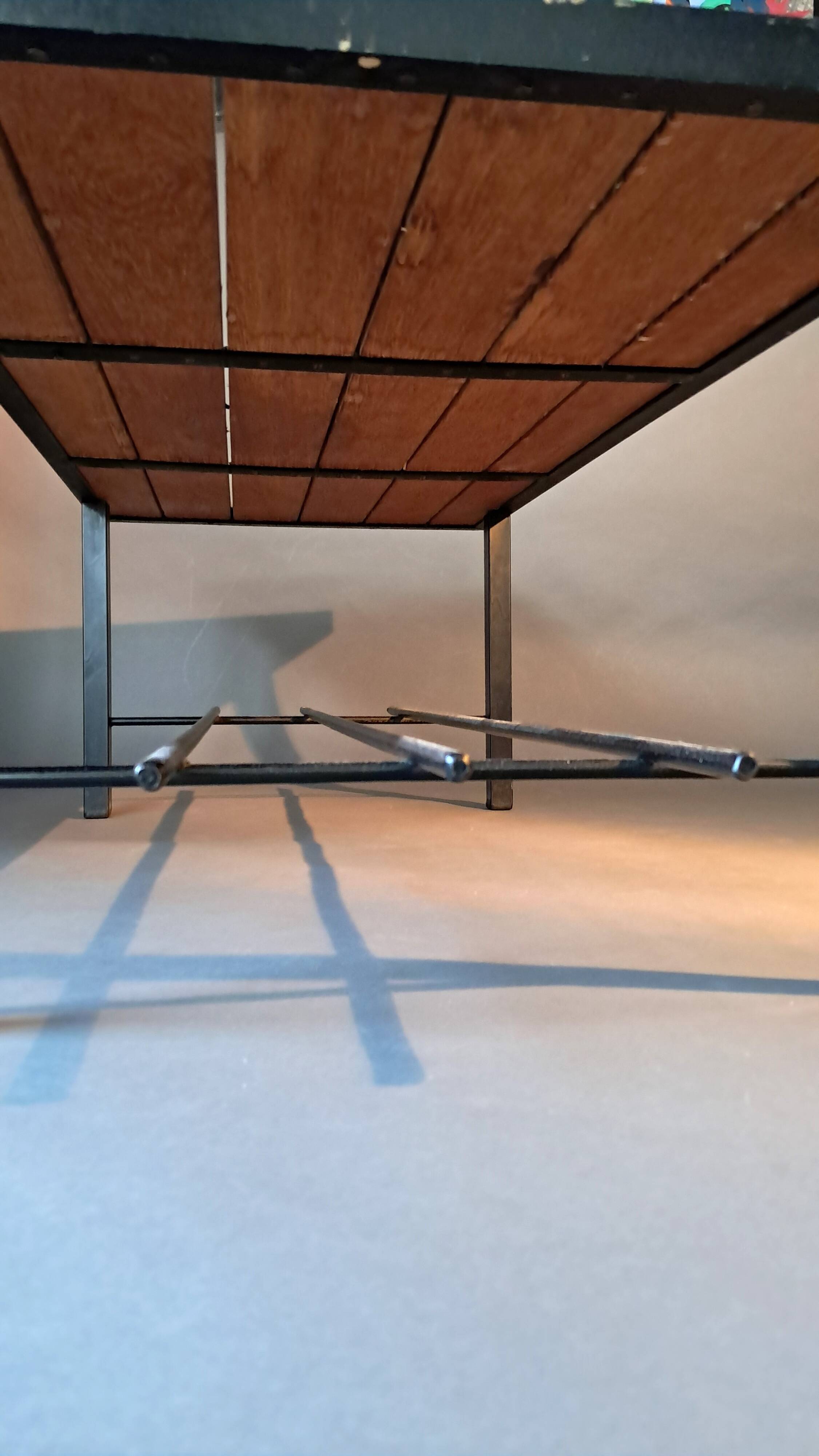 Vintage modernist coffee table in teak and black metal.