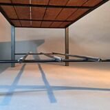 Vintage modernist coffee table in teak and black metal.