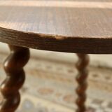 Vintage circular side table in wood with turned legs.