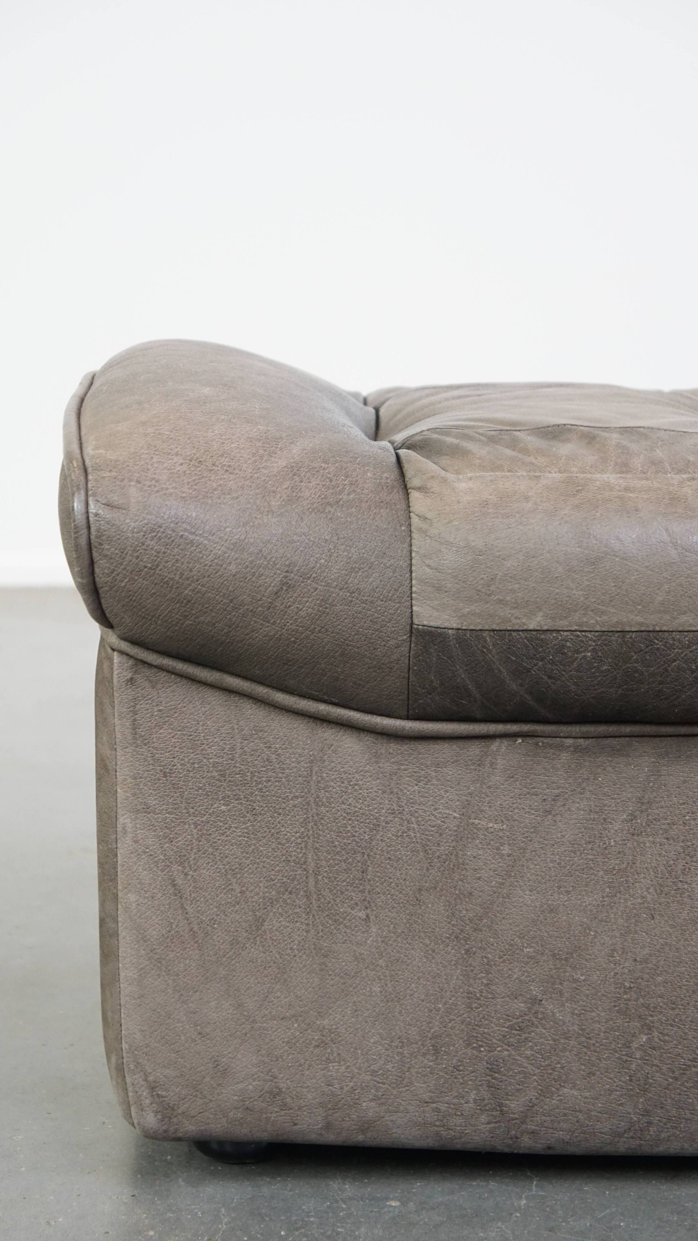 Luxurious, comfortable, gray leather vintage footstool